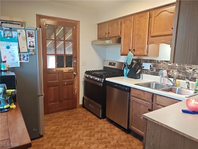 3211 Latimer Ave, Ashtabula, OH 44004 - kitchen with stainless steel appliances, under cabinet range hood, light countertops, backsplash, and light floors