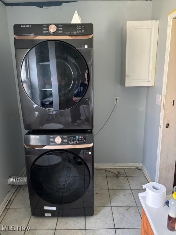 4896 High Hill Rd, Cambridge, OH 43725 - washroom featuring cabinet space, estacked washer and dryer, and light tile patterned floors