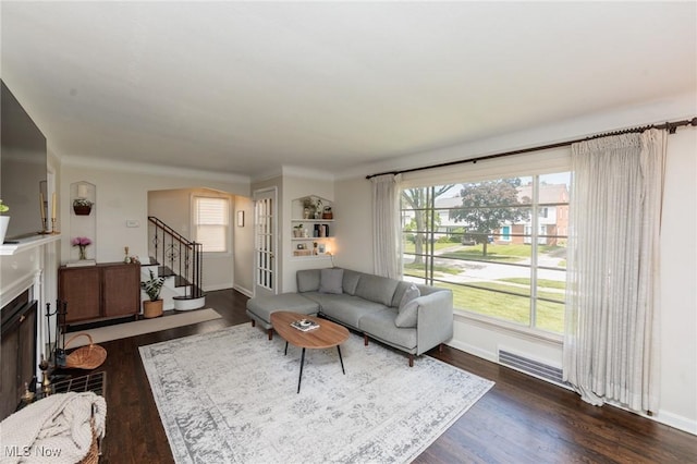 4410 Silsby Rd, University Heights, OH 44118 - living room with stairs, dark wood finished floors, and a fireplace
