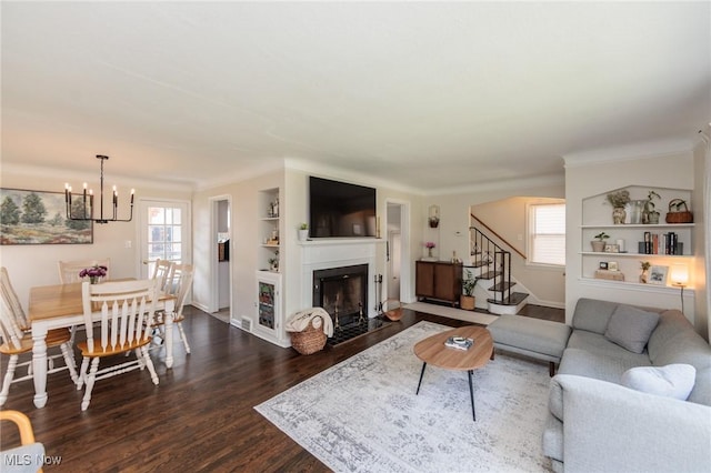 4410 Silsby Rd, University Heights, OH 44118 - living area featuring plenty of natural light, dark wood finished floors, stairway, and a chandelier