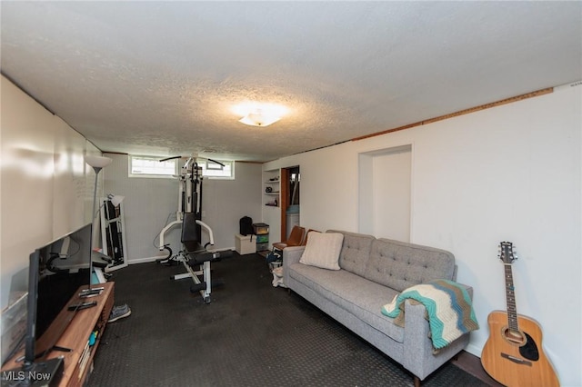 4410 Silsby Rd, University Heights, OH 44118 - workout room featuring a textured ceiling and baseboards