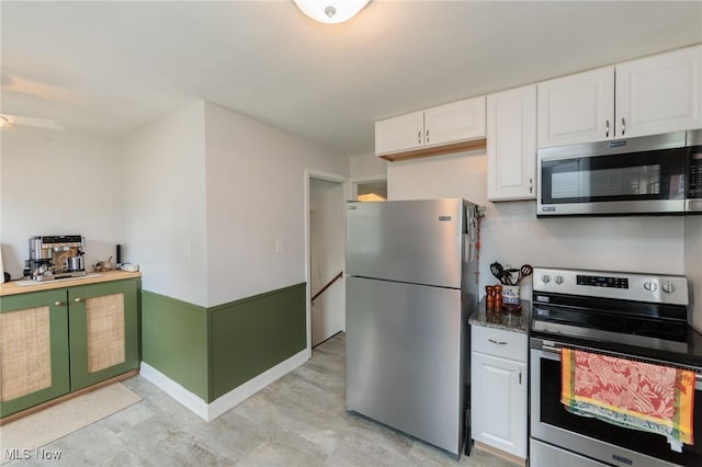 4410 Silsby Rd, University Heights, OH 44118 - kitchen with stainless steel appliances, white cabinetry, and a ceiling fan