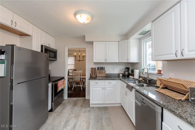 4410 Silsby Rd, University Heights, OH 44118 - kitchen with stainless steel appliances, light wood-type flooring, and white cabinets