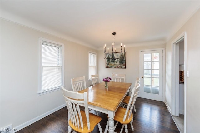4410 Silsby Rd, University Heights, OH 44118 - dining room featuring a chandelier, plenty of natural light, and dark wood-style flooring