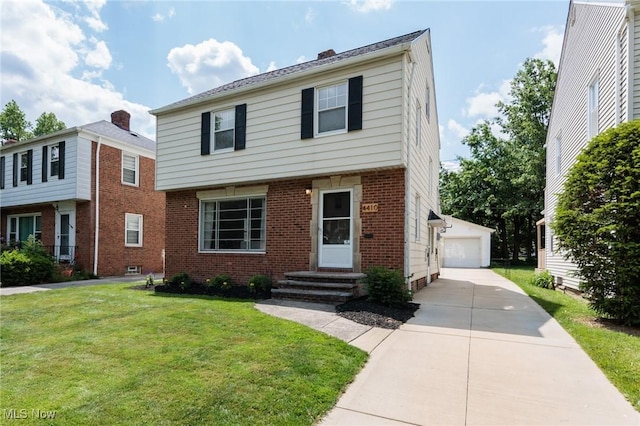 4410 Silsby Rd, University Heights, OH 44118 - colonial-style house with entry steps, a front yard, an outdoor structure, brick siding, and a garage