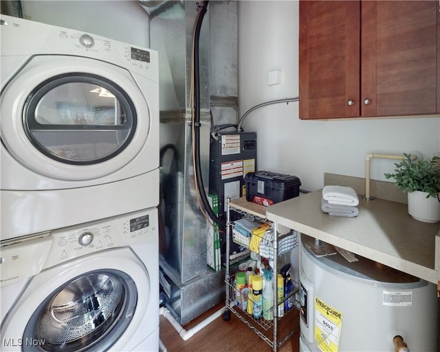 1846 Front St Unit 402, Cuyahoga Falls, OH 44221 - laundry area with stacked washer and clothes dryer, water heater, cabinet space, and wood finished floors