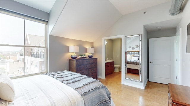 1846 Front St Unit 402, Cuyahoga Falls, OH 44221 - bedroom with light wood-type flooring, lofted ceiling, and ensuite bath