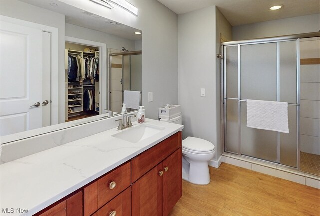 1846 Front St Unit 402, Cuyahoga Falls, OH 44221 - full bathroom with vanity, a shower stall, wood finished floors, a walk in closet, and recessed lighting