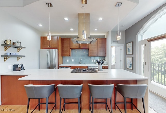 1846 Front St Unit 402, Cuyahoga Falls, OH 44221 - kitchen featuring stainless steel appliances, island exhaust hood, brown cabinetry, light countertops, and open shelves