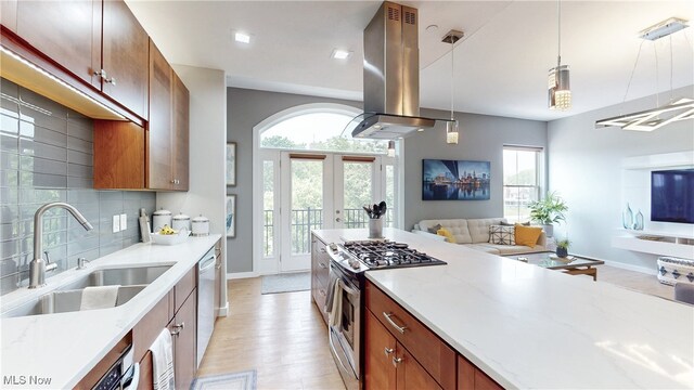 1846 Front St Unit 402, Cuyahoga Falls, OH 44221 - kitchen with island range hood, stainless steel appliances, open floor plan, light wood-type flooring, and tasteful backsplash