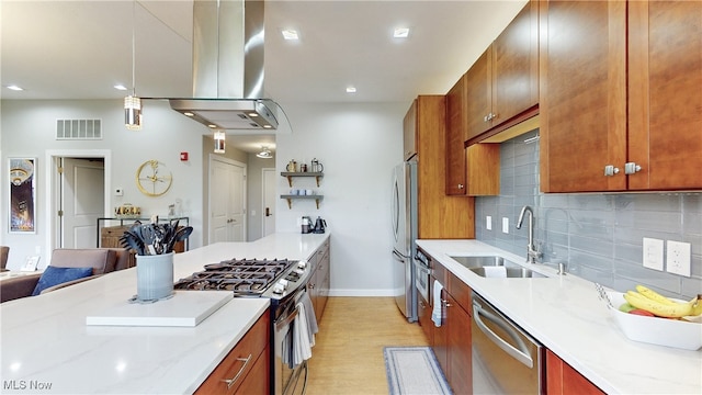 1846 Front St Unit 402, Cuyahoga Falls, OH 44221 - kitchen featuring stainless steel appliances, island range hood, light wood-type flooring, backsplash, and light stone counters