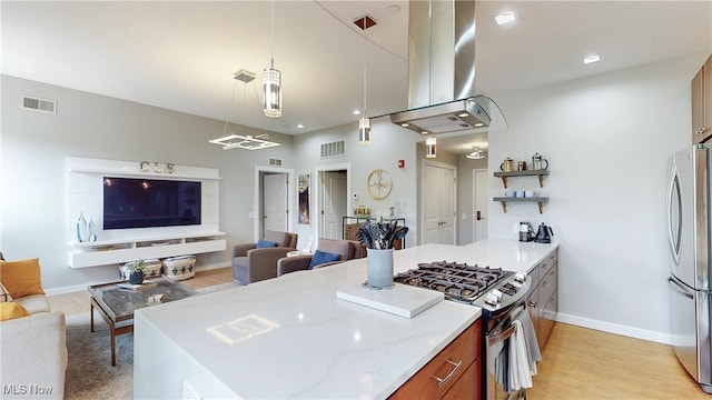 1846 Front St Unit 402, Cuyahoga Falls, OH 44221 - kitchen with stainless steel appliances, island range hood, open floor plan, brown cabinets, and light stone counters
