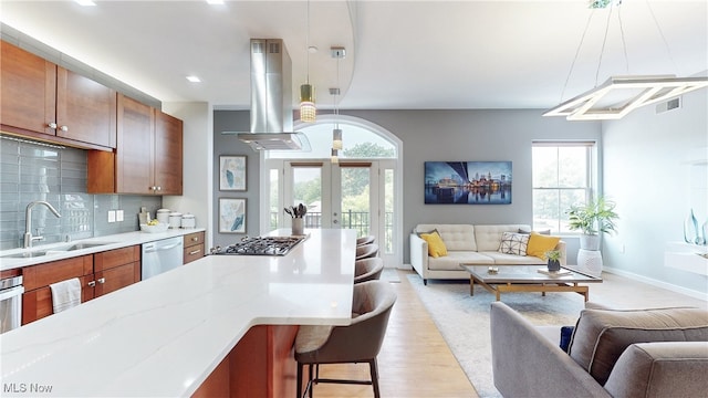 1846 Front St Unit 402, Cuyahoga Falls, OH 44221 - kitchen with island range hood, appliances with stainless steel finishes, open floor plan, french doors, and backsplash