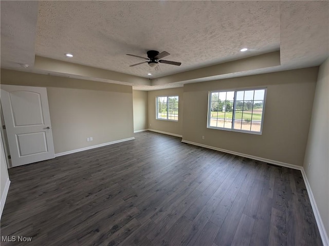 41861 State Route 303, Lagrange, OH 44050 - unfurnished room featuring a textured ceiling, ceiling fan, a raised ceiling, dark wood finished floors, and recessed lighting