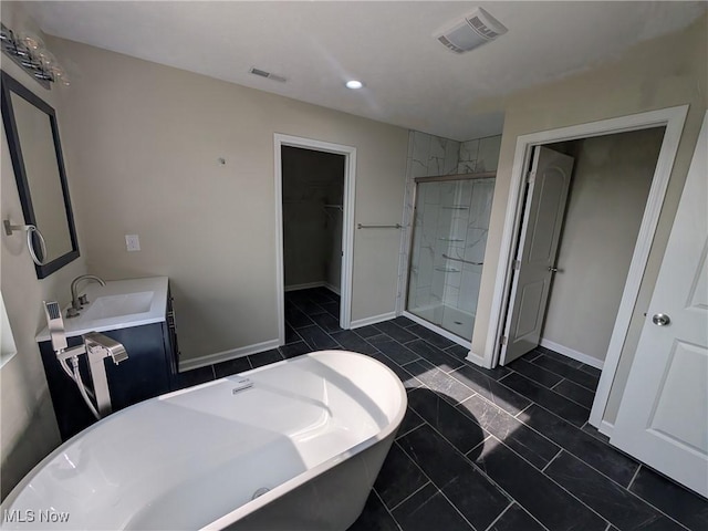 41861 State Route 303, Lagrange, OH 44050 - full bathroom with a freestanding tub, a shower stall, a spacious closet, vanity, and recessed lighting