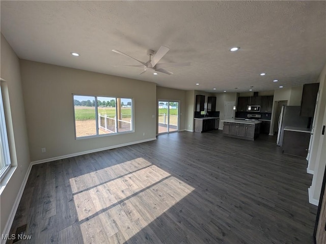 41861 State Route 303, Lagrange, OH 44050 - unfurnished living room with ceiling fan, dark wood-type flooring, recessed lighting, and a textured ceiling