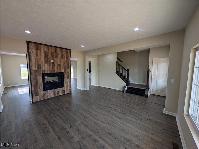 41861 State Route 303, Lagrange, OH 44050 - unfurnished living room featuring stairs, dark wood-style flooring, recessed lighting, and a fireplace