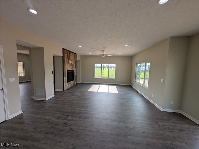41861 State Route 303, Lagrange, OH 44050 - unfurnished living room featuring recessed lighting, dark wood-style floors, a textured ceiling, a ceiling fan, and a tile fireplace