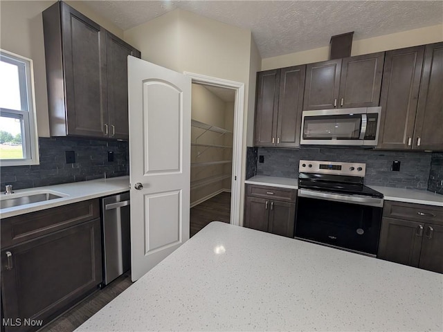 41861 State Route 303, Lagrange, OH 44050 - kitchen with appliances with stainless steel finishes, wood finished floors, backsplash, and a textured ceiling