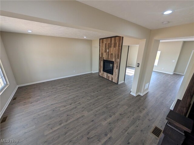 41861 State Route 303, Lagrange, OH 44050 - unfurnished living room with a tile fireplace, dark wood-type flooring, and recessed lighting