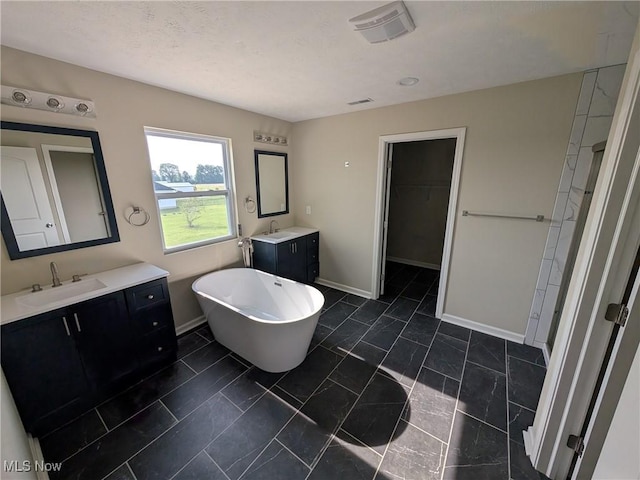 41861 State Route 303, Lagrange, OH 44050 - bathroom featuring two vanities, a freestanding tub, and a spacious closet