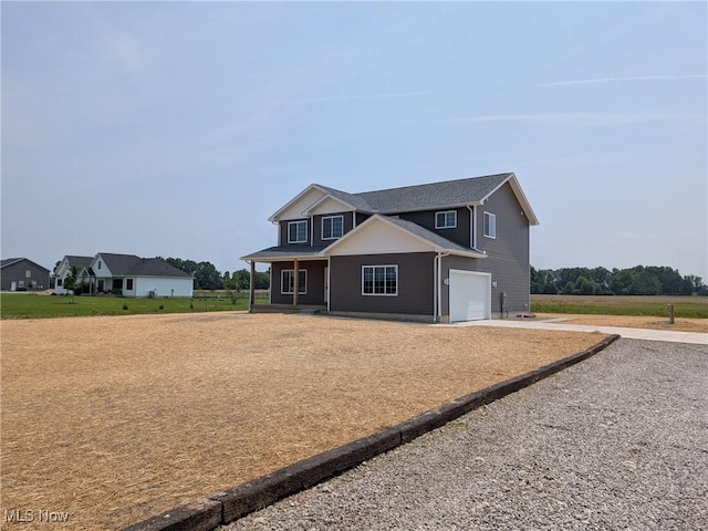 41861 State Route 303, Lagrange, OH 44050 - view of front of house with concrete driveway, a garage, and covered porch
