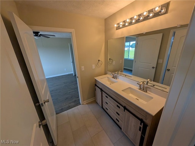 41861 State Route 303, Lagrange, OH 44050 - full bath with double vanity, tile patterned flooring, a textured ceiling, and a ceiling fan