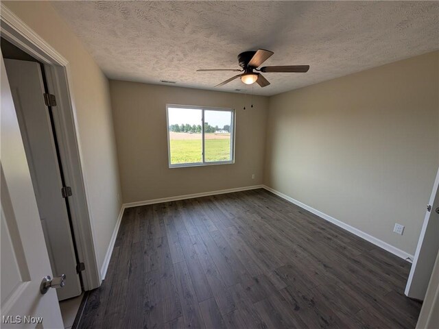 41861 State Route 303, Lagrange, OH 44050 - spare room featuring ceiling fan, a textured ceiling, and dark wood finished floors