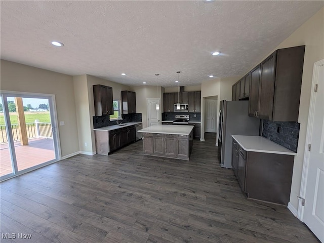 41861 State Route 303, Lagrange, OH 44050 - kitchen featuring appliances with stainless steel finishes, a textured ceiling, backsplash, dark wood finished floors, and recessed lighting