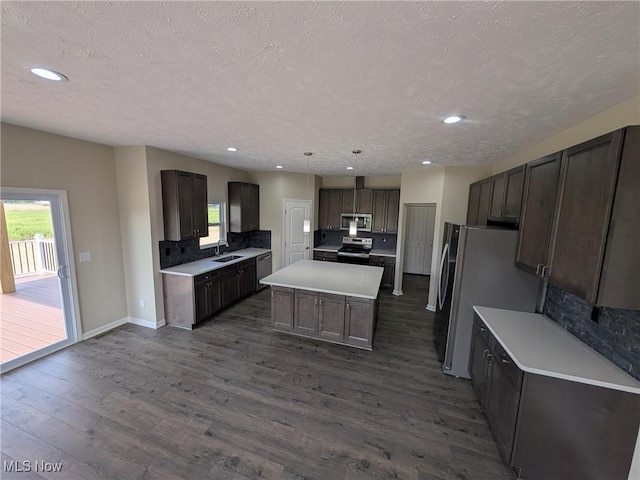 41861 State Route 303, Lagrange, OH 44050 - kitchen featuring stainless steel appliances, tasteful backsplash, a kitchen island, dark wood-style flooring, and recessed lighting