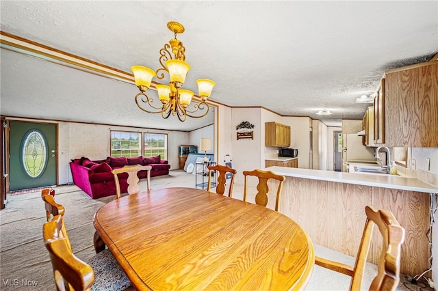6835 Sidley Rd, Thompson, OH 44086 - dining space with a chandelier, a textured ceiling, and light carpet