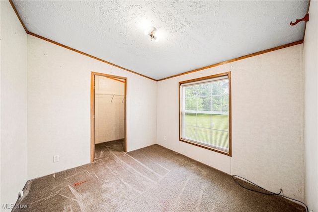6835 Sidley Rd, Thompson, OH 44086 - unfurnished bedroom with crown molding, carpet, a textured ceiling, lofted ceiling, and a closet