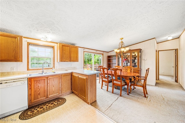 6835 Sidley Rd, Thompson, OH 44086 - kitchen with white dishwasher, lofted ceiling, a chandelier, a textured ceiling, and a peninsula