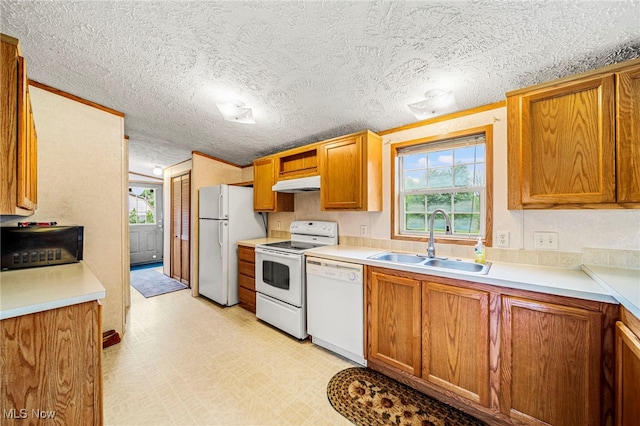 6835 Sidley Rd, Thompson, OH 44086 - kitchen featuring white appliances, under cabinet range hood, light floors, brown cabinets, and a textured ceiling