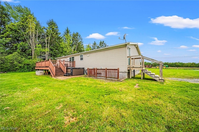 6835 Sidley Rd, Thompson, OH 44086 - back of house with a wooden deck, stairs, and a lawn