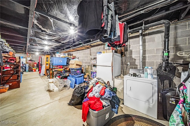 6835 Sidley Rd, Thompson, OH 44086 - unfinished below grade area featuring washer / clothes dryer and freestanding refrigerator