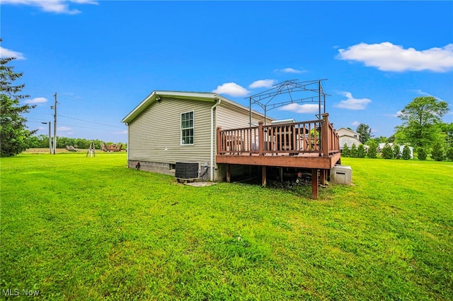 6835 Sidley Rd, Thompson, OH 44086 - rear view of house with a wooden deck, a lawn, and crawl space