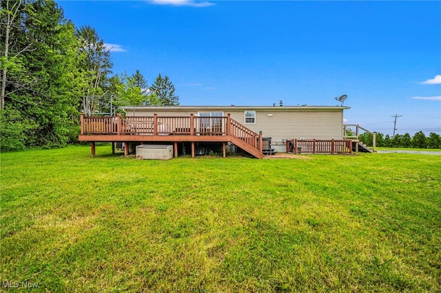 6835 Sidley Rd, Thompson, OH 44086 - back of property with a wooden deck and a lawn