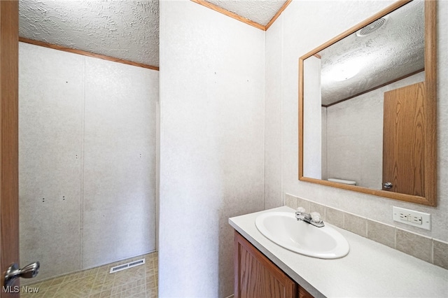 6835 Sidley Rd, Thompson, OH 44086 - bathroom with vanity, a textured ceiling, and ornamental molding