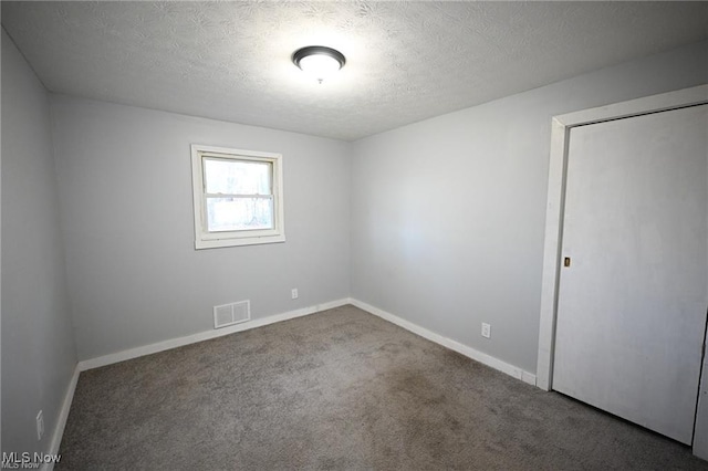5203 Forest Ave, Maple Heights, OH 44137 - carpeted empty room with baseboards and a textured ceiling