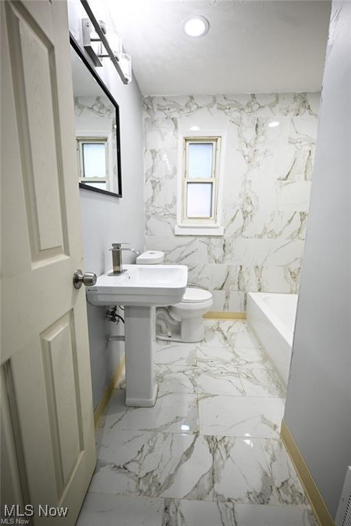 5203 Forest Ave, Maple Heights, OH 44137 - bathroom featuring healthy amount of natural light, a bathtub, and recessed lighting