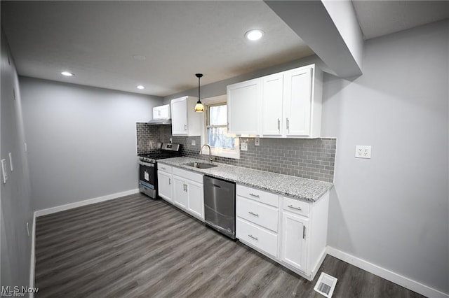 5203 Forest Ave, Maple Heights, OH 44137 - kitchen with stainless steel appliances, dark wood-style floors, white cabinets, tasteful backsplash, and recessed lighting