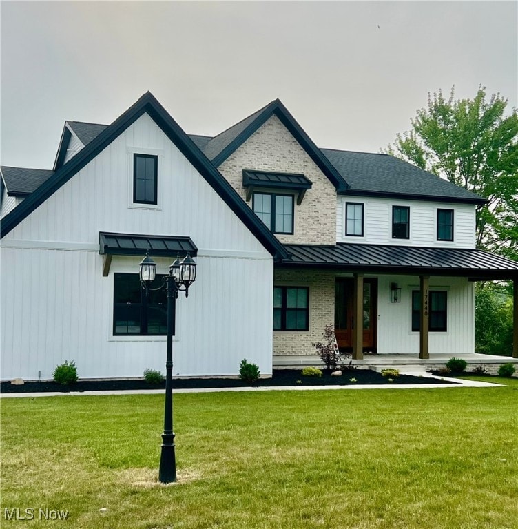 17440 Sawgrass Cir, North Royalton, OH 44133 - modern farmhouse style home with a standing seam roof, a metal roof, a porch, and a front yard