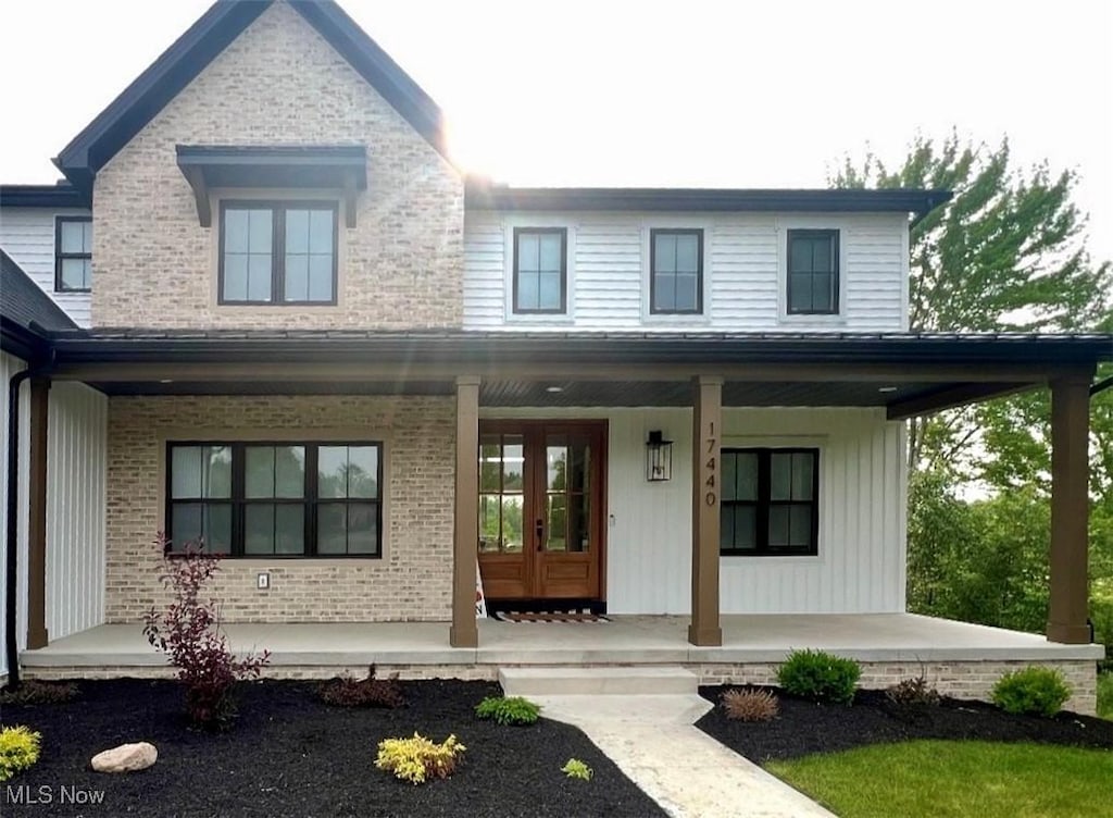 17440 Sawgrass Cir, North Royalton, OH 44133 - view of front of home with covered porch, french doors, and brick siding