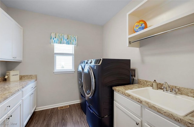13861 Woodhawk Dr, Strongsville, OH 44136 - washroom featuring separate washer and dryer, cabinet space, and dark wood-style flooring