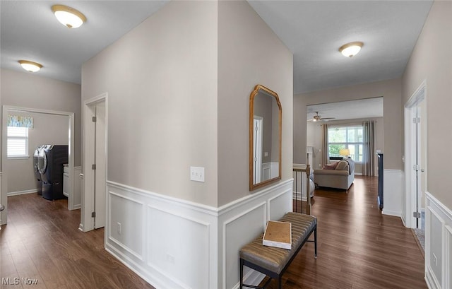 13861 Woodhawk Dr, Strongsville, OH 44136 - hallway featuring washer / dryer, wainscoting, dark wood finished floors, and a decorative wall