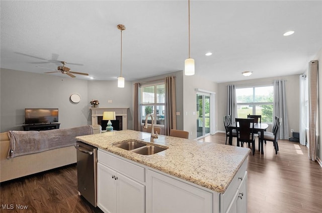 13861 Woodhawk Dr, Strongsville, OH 44136 - kitchen with open floor plan, stainless steel dishwasher, white cabinetry, plenty of natural light, and recessed lighting