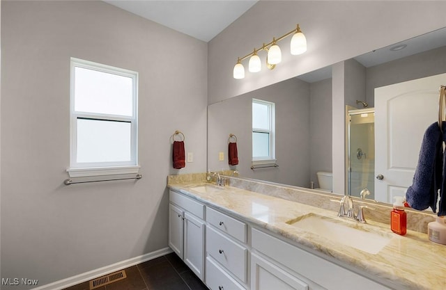 13861 Woodhawk Dr, Strongsville, OH 44136 - full bathroom with double vanity, a shower with shower door, and tile patterned floors