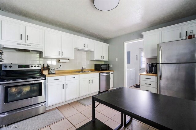 5672 Stanford Ave, Youngstown, OH 44515 - kitchen featuring stainless steel appliances, under cabinet range hood, white cabinetry, and a textured ceiling