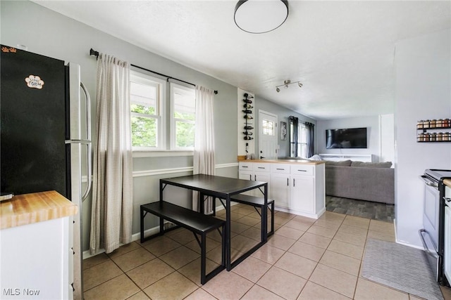 5672 Stanford Ave, Youngstown, OH 44515 - kitchen with white cabinets, appliances with stainless steel finishes, light tile patterned floors, butcher block countertops, and open floor plan